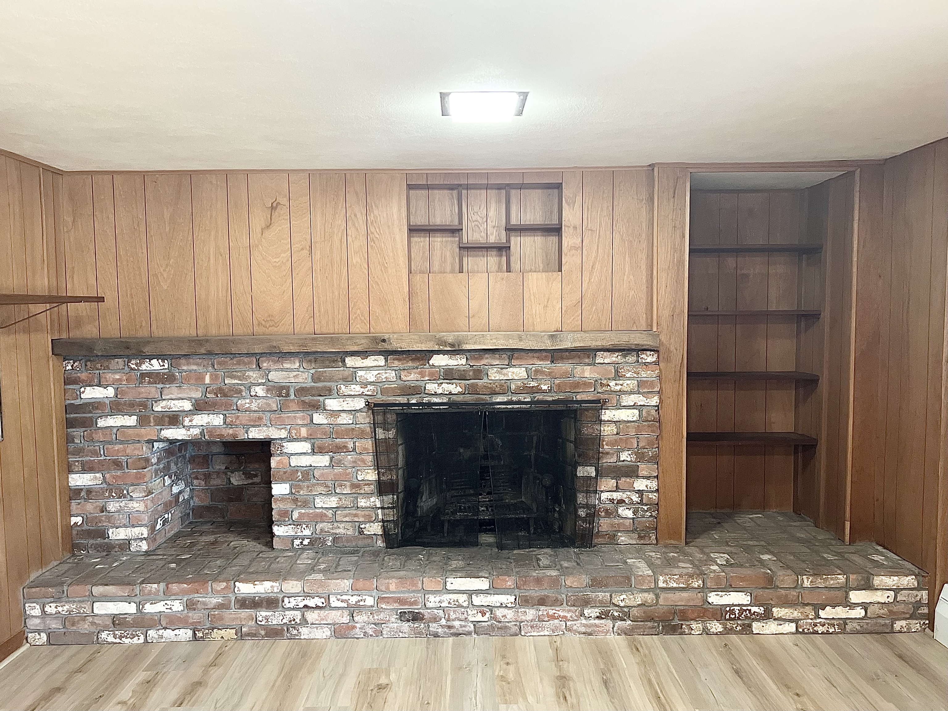 524 Saybrook Road Haddam, CT 06438 - Photo 34 of 38 a living room with a fireplace and a wooden floor
