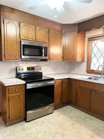 a spacious bathroom with a sink a large mirror and a bathtub