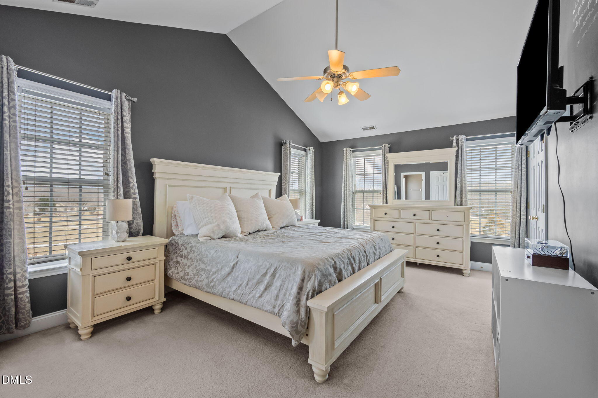 51 Water Front Lane Timberlake, NC 27583 - Photo 22 of 57 a spacious bedroom with a bed and a chandelier