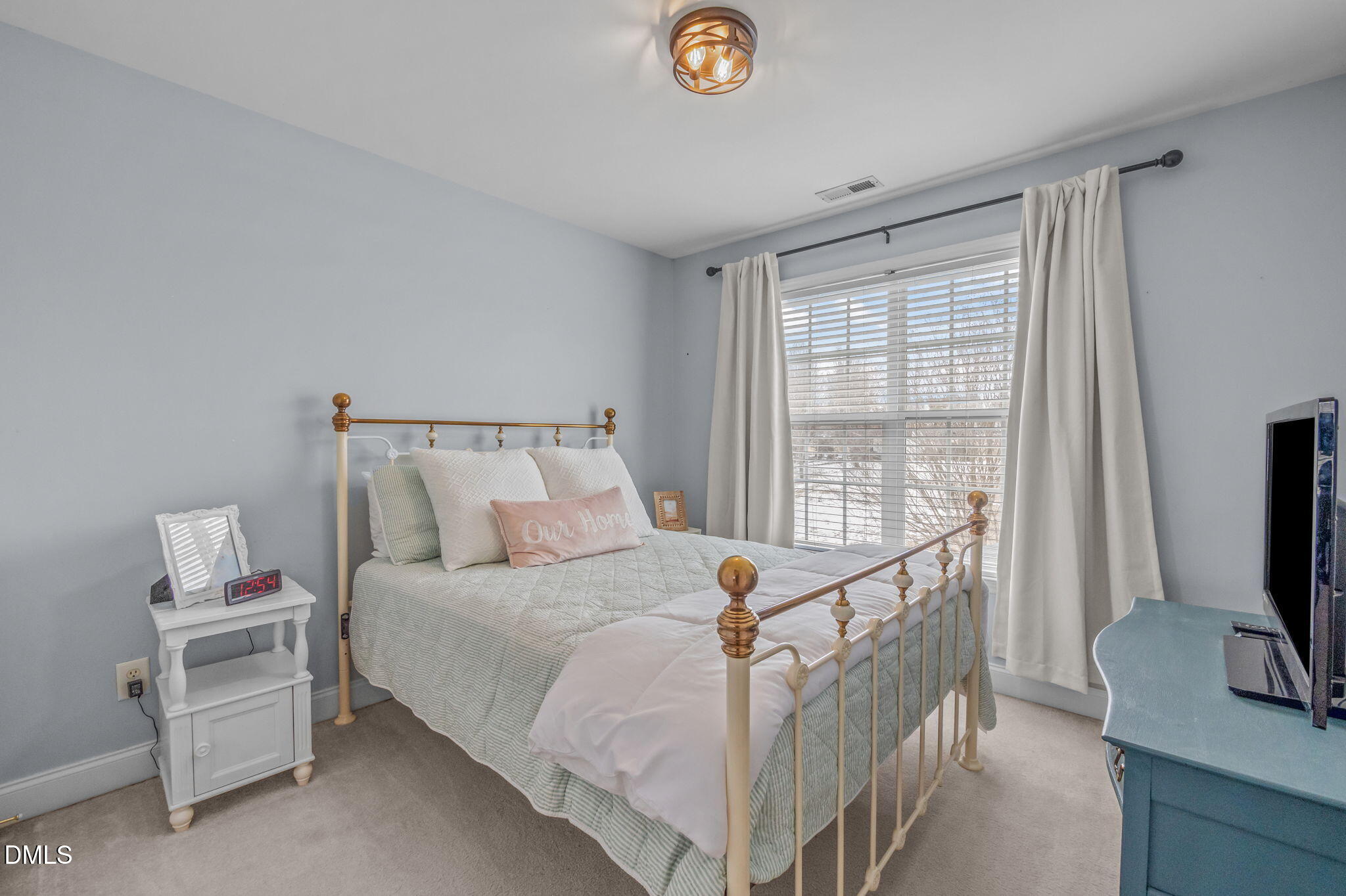 51 Water Front Lane Timberlake, NC 27583 - Photo 29 of 57 a bed room with a bed a television and a window