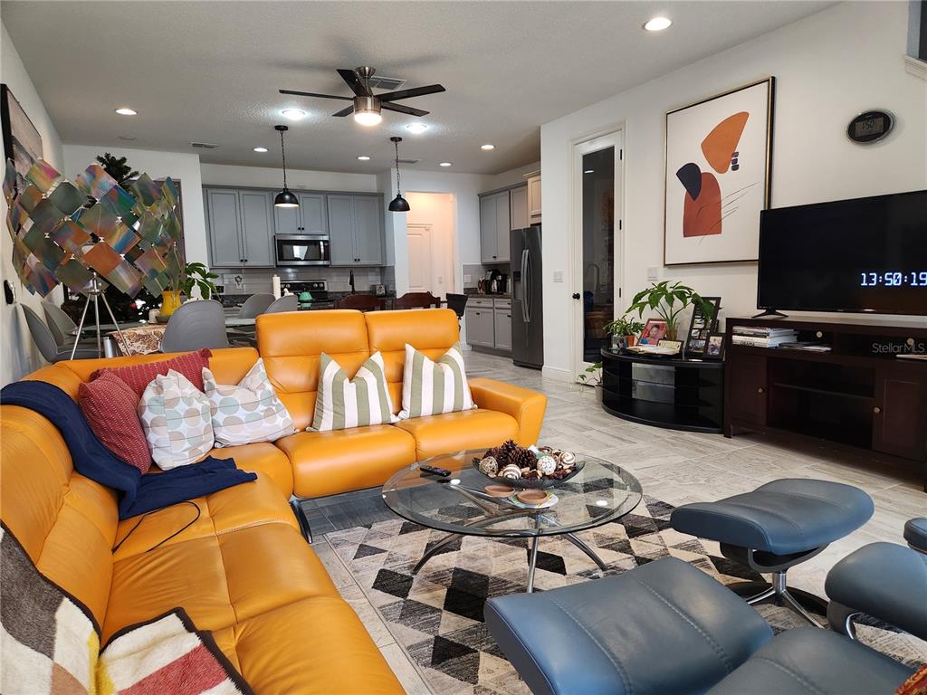 5508 Viola Lee Way Lutz, FL 33558 - Photo 17 of 60 a living room with furniture kitchen and a flat screen tv