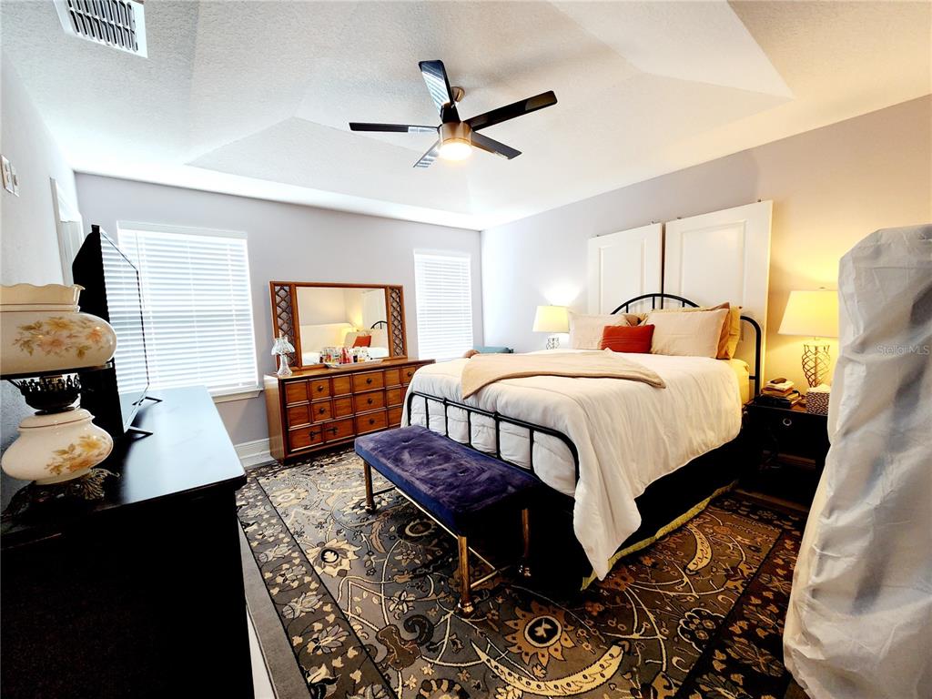 5508 Viola Lee Way Lutz, FL 33558 - Photo 23 of 60 a bedroom with a bed and wooden floor