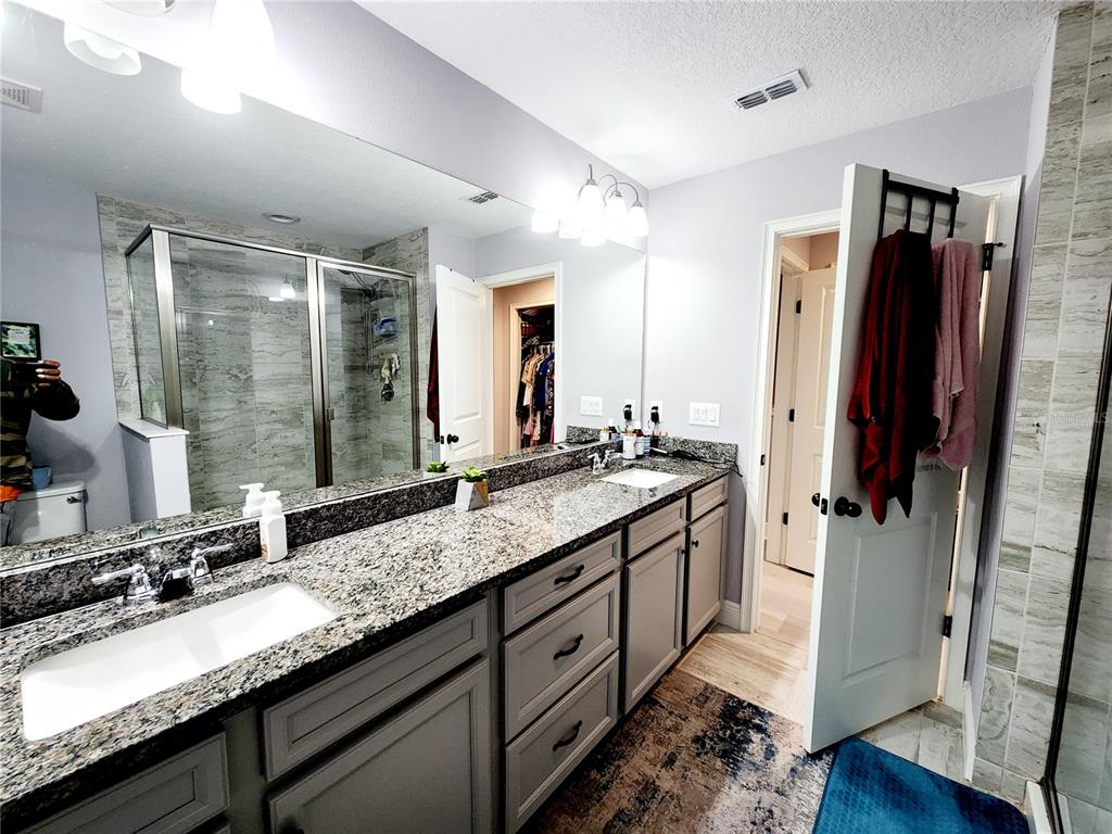 5508 Viola Lee Way Lutz, FL 33558 - Photo 28 of 60 a bathroom with double vanity and a mirror