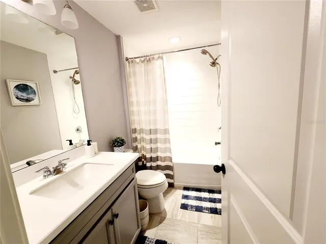 a bathroom with a sink toilet and a mirror