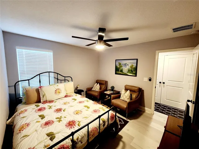 a view of a house with backyard and sitting area