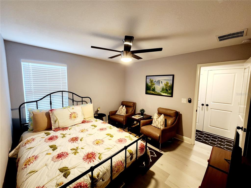 5508 Viola Lee Way Lutz, FL 33558 - Photo 45 of 60 a bedroom with a bed and wooden floor