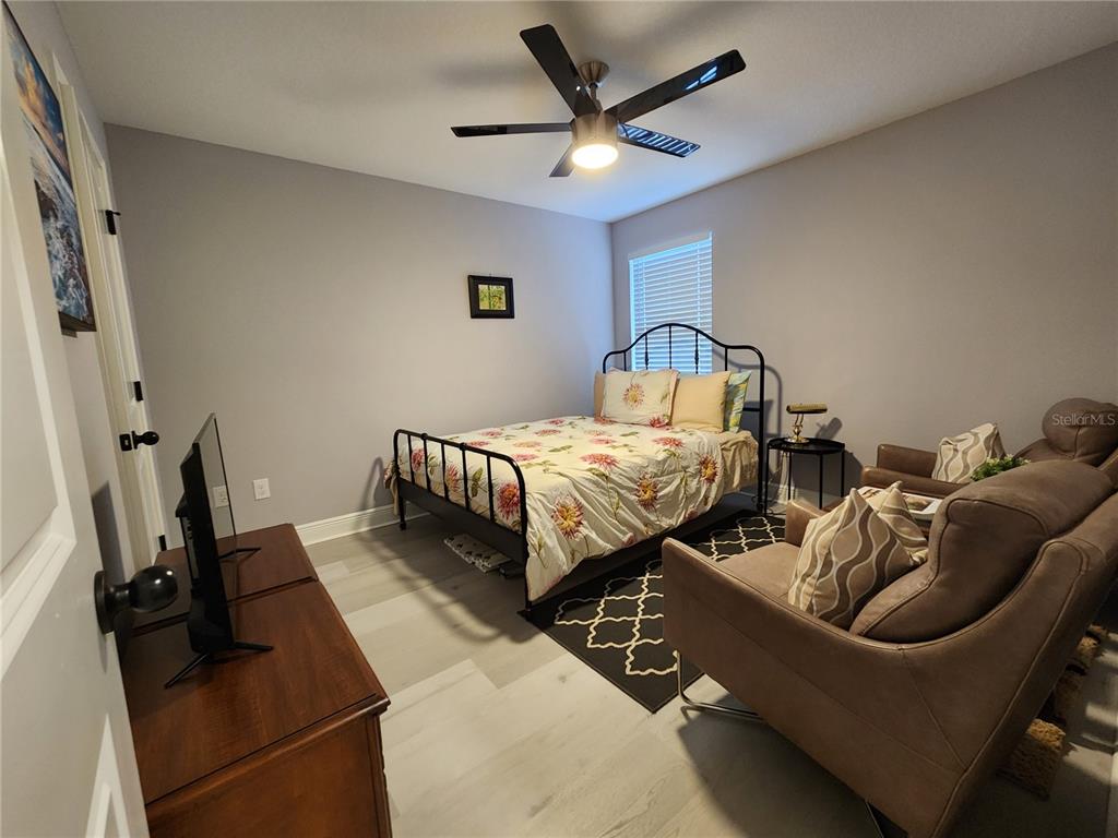 5508 Viola Lee Way Lutz, FL 33558 - Photo 46 of 60 a bed room with two bed and a ceiling fan