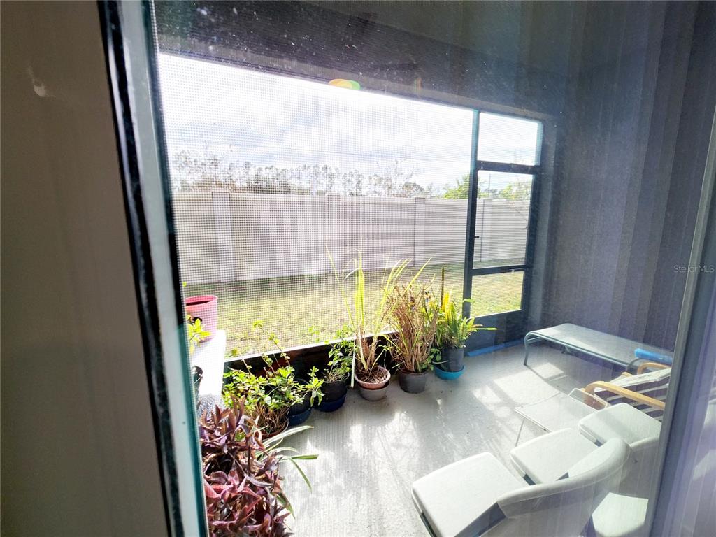 5508 Viola Lee Way Lutz, FL 33558 - Photo 52 of 60 a view of a living room and a floor to ceiling window