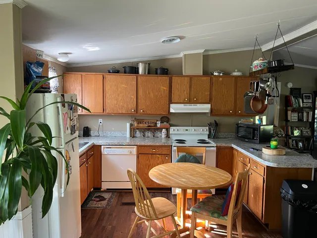 a kitchen with stainless steel appliances kitchen island granite countertop a sink and cabinets