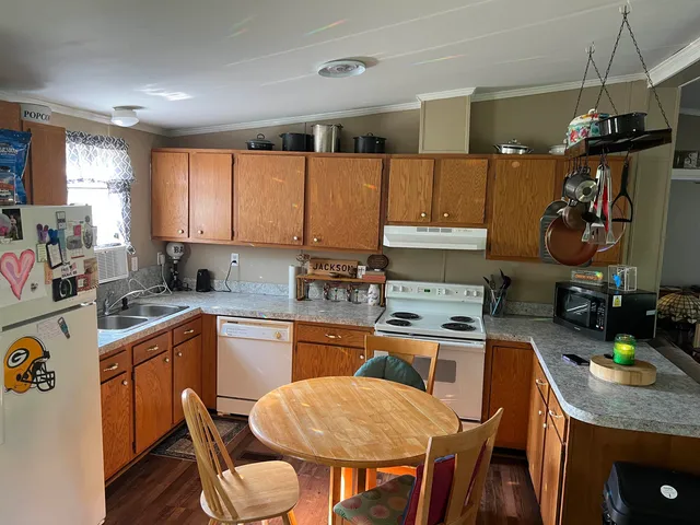a kitchen with a table chairs stove and cabinets