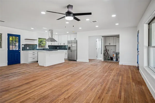 a view of kitchen with sink and refrigerator