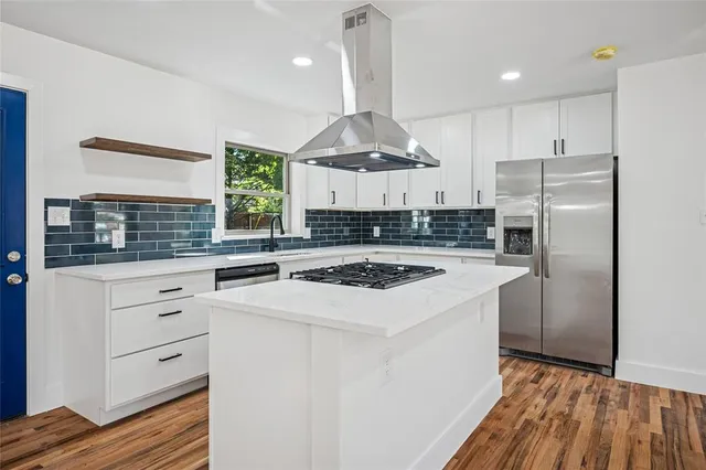 a kitchen with a stove a refrigerator and a sink