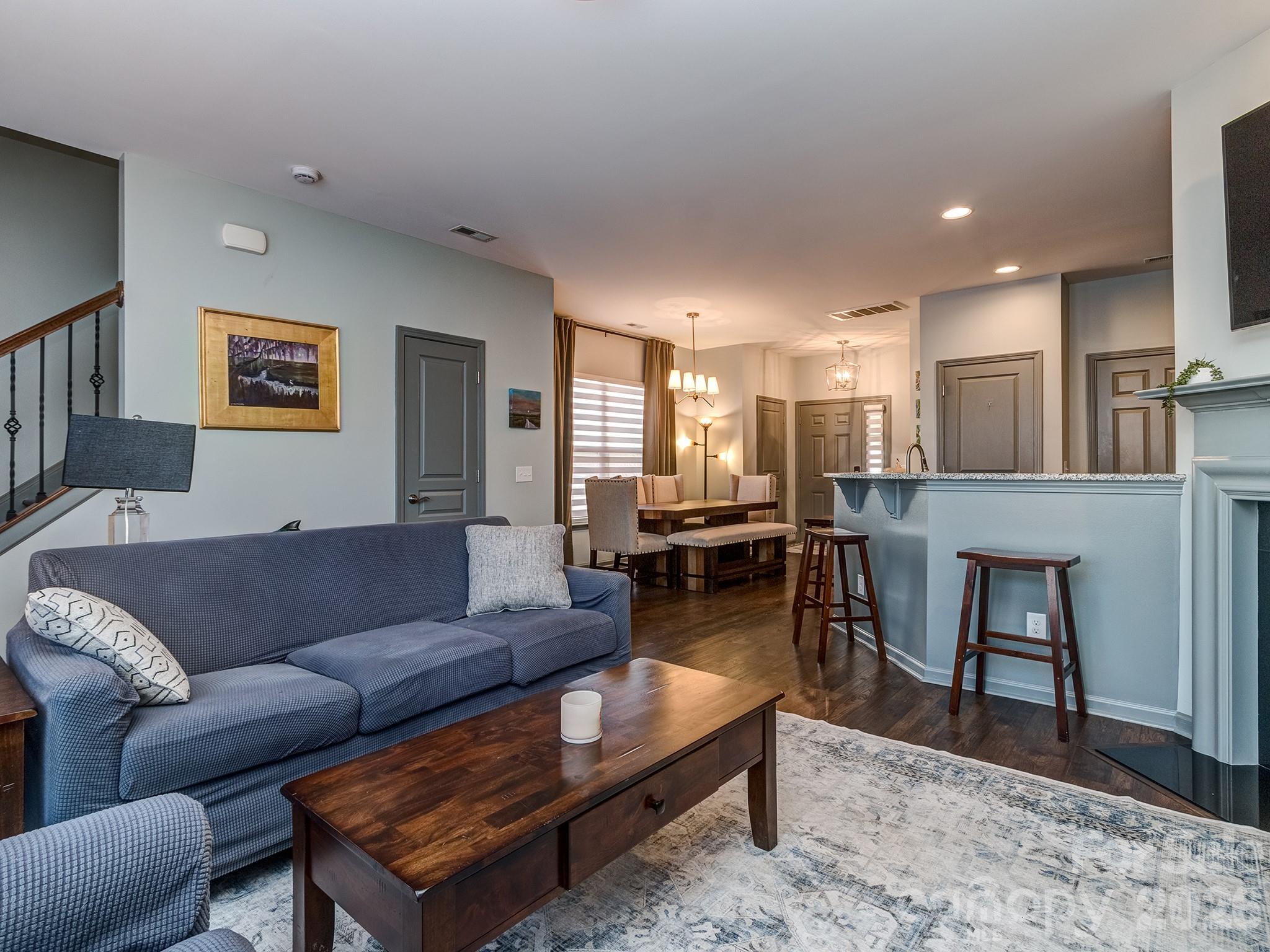 6236 Rockefeller Lane Charlotte, NC 28210 - Photo 11 of 26 a living room with furniture and a dining table with kitchen view