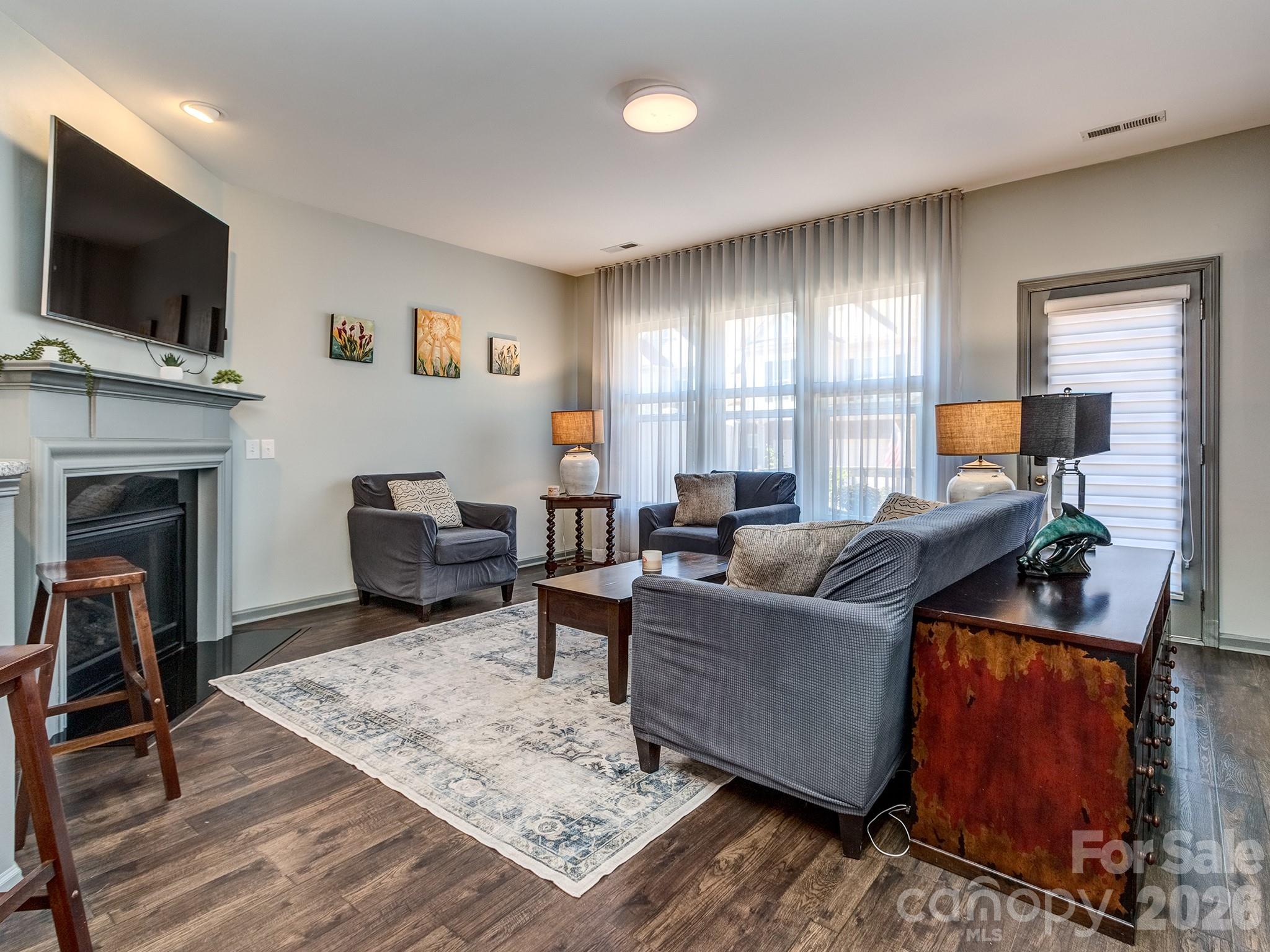 6236 Rockefeller Lane Charlotte, NC 28210 - Photo 13 of 26 a living room with furniture a flat screen tv and a fireplace