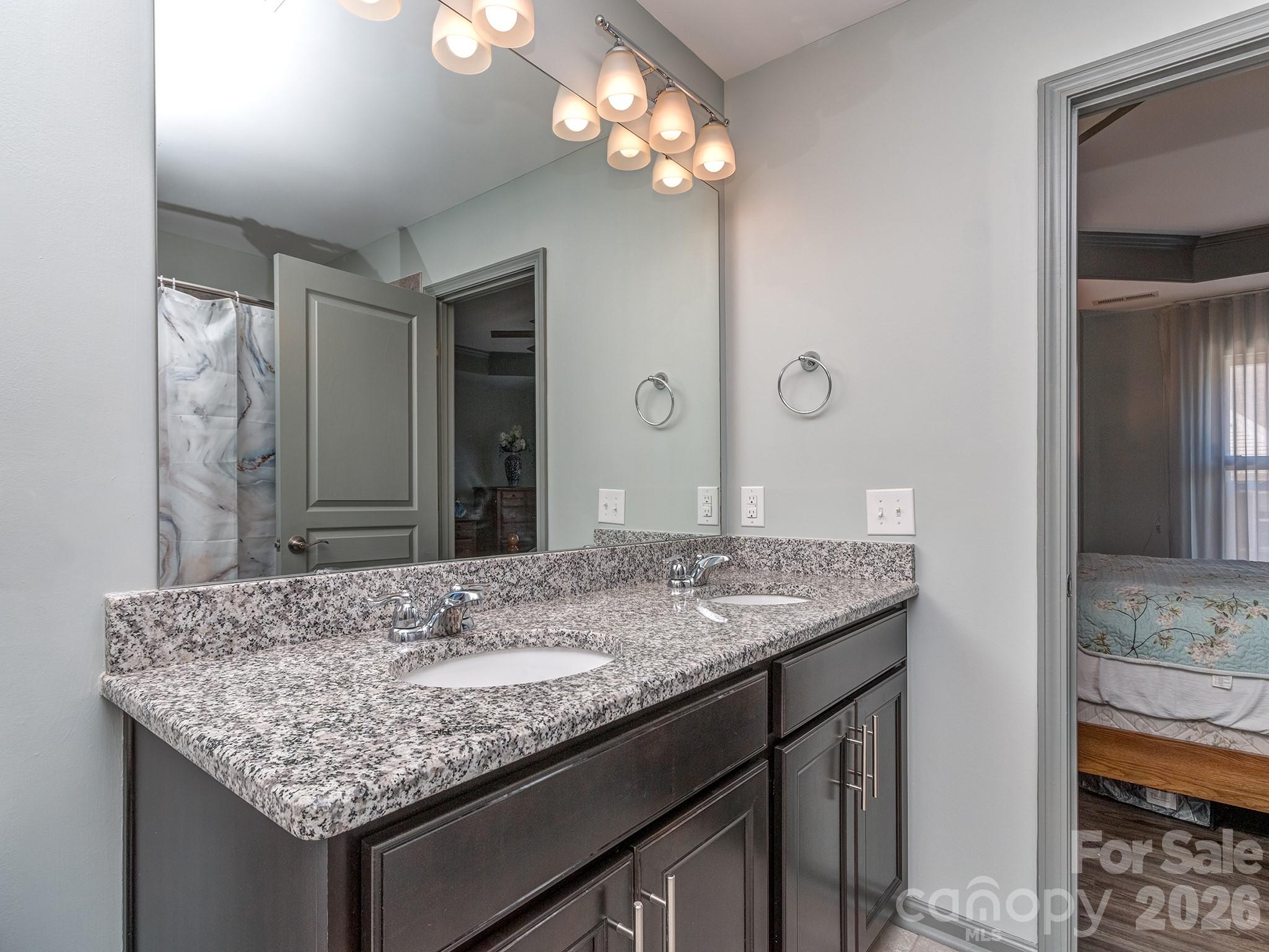 6236 Rockefeller Lane Charlotte, NC 28210 - Photo 18 of 26 a bathroom with a granite countertop sink and a mirror