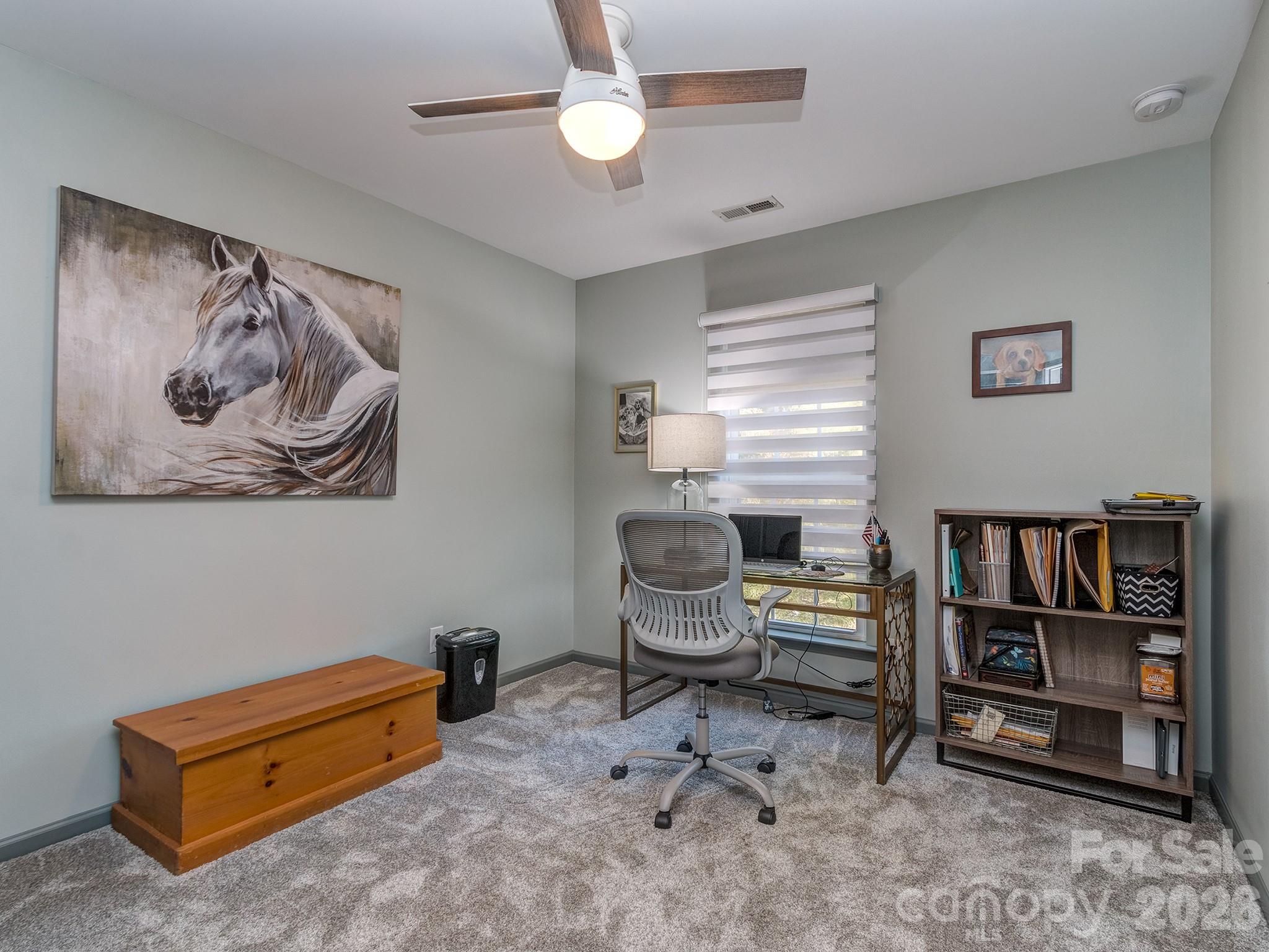 6236 Rockefeller Lane Charlotte, NC 28210 - Photo 19 of 26 a bedroom with furniture and a book shelf
