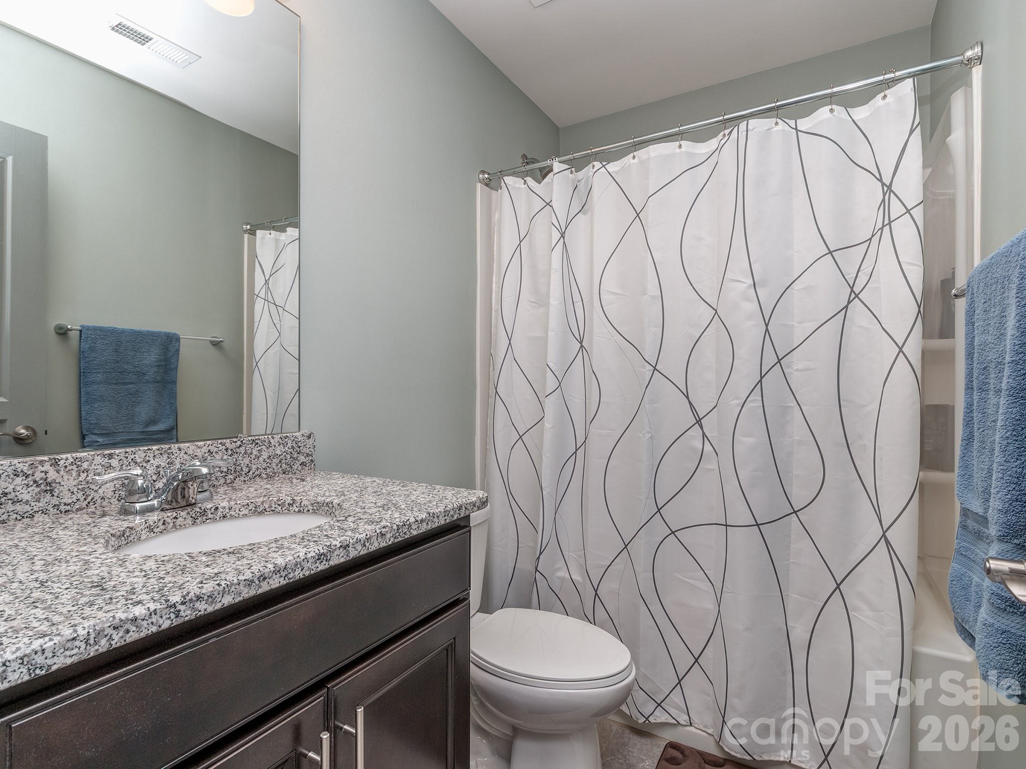 6236 Rockefeller Lane Charlotte, NC 28210 - Photo 21 of 26 a bathroom with a granite countertop sink and a mirror