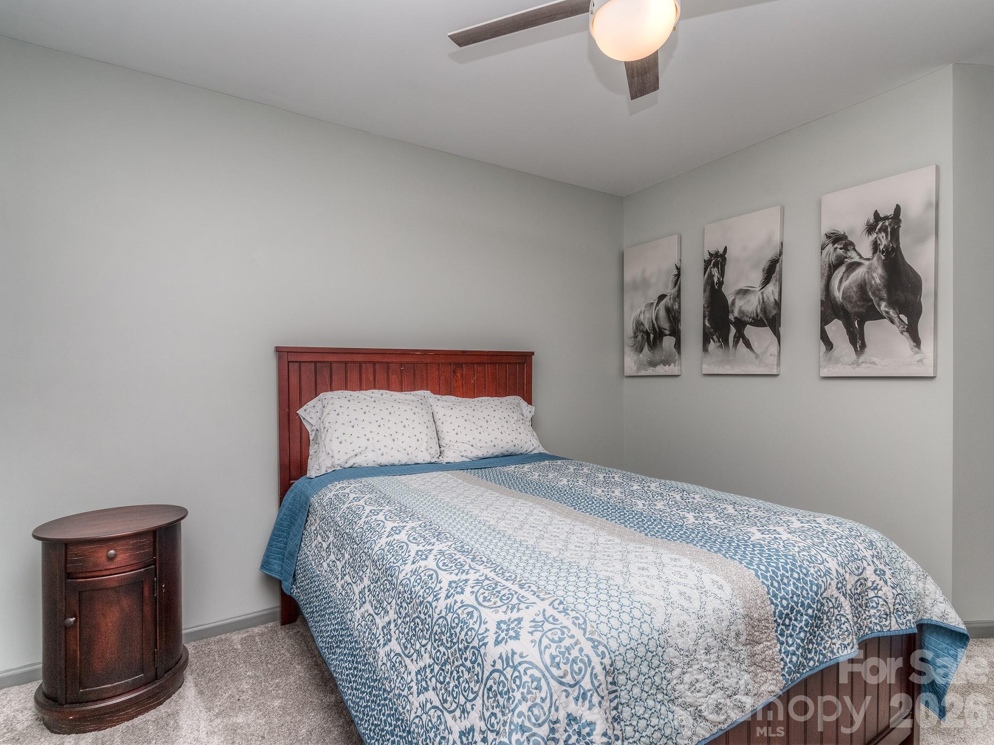 6236 Rockefeller Lane Charlotte, NC 28210 - Photo 23 of 26 a bedroom with a bed and a chandelier