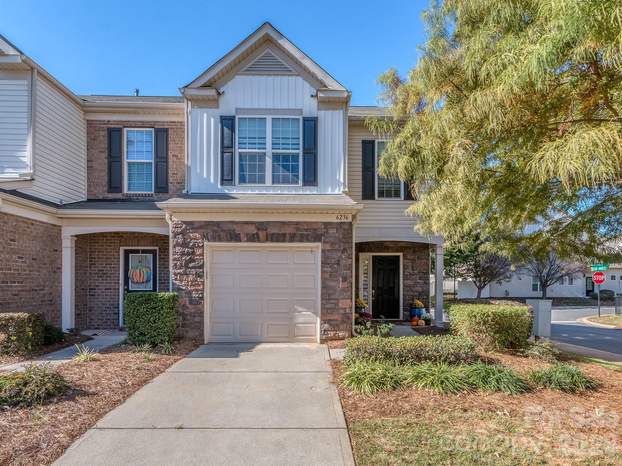 6236 Rockefeller Lane Charlotte, NC 28210 - Photo 3 of 26 a front view of a house with a yard and garage