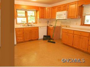661 Thompson Cove Road Clyde, NC 28721 - Photo 2 of 7 a view of a kitchen with a sink a window and cabinets