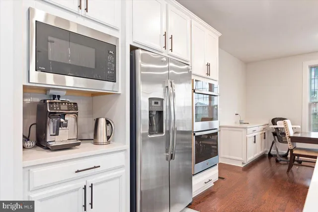 a kitchen with a refrigerator and microwave