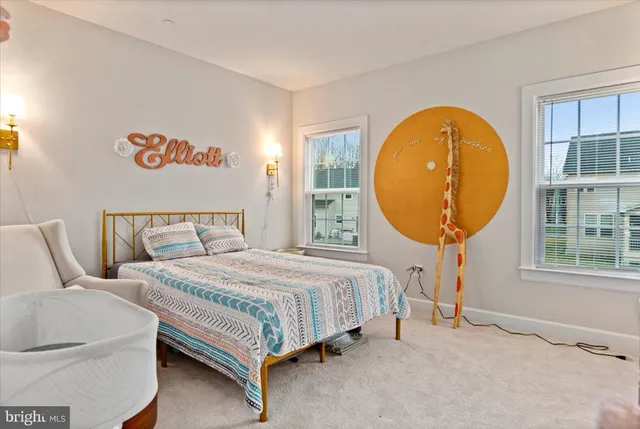 a bedroom with a bed a mirror and a window