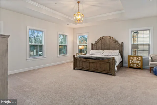 a bedroom with a bed window and a chair