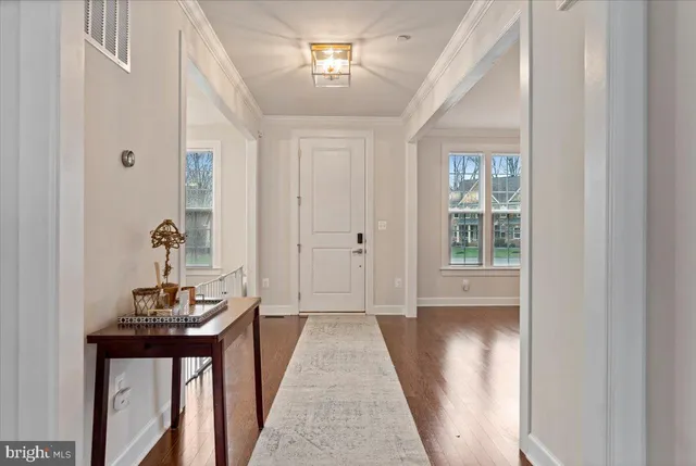 a view of a hallway to a livingroom with furniture