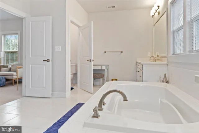 a spacious bathroom with a sink and a bathtub
