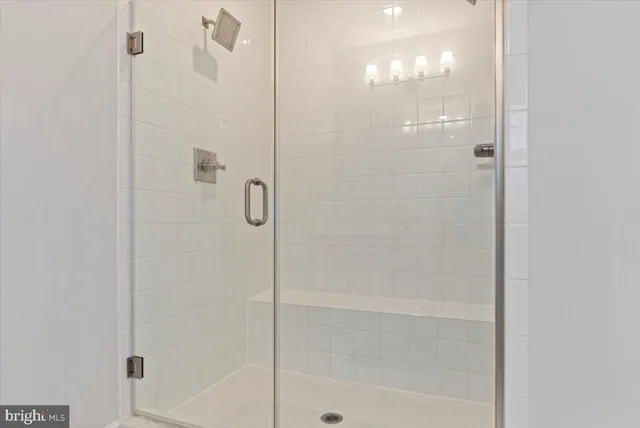 a bathroom with a glass shower door