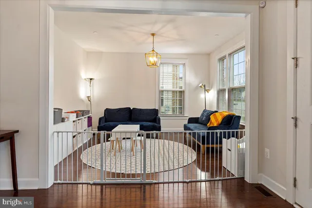a living room with furniture a window and gym equipment