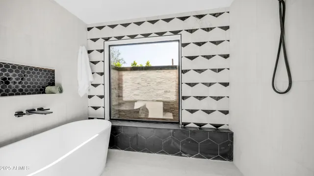 a bathroom with a bathtub and shower