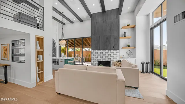 a living room with furniture fireplace and a large window