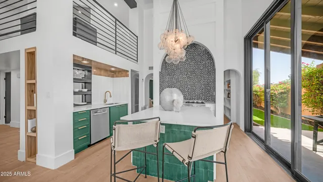 a view of a dining room with furniture and chandelier