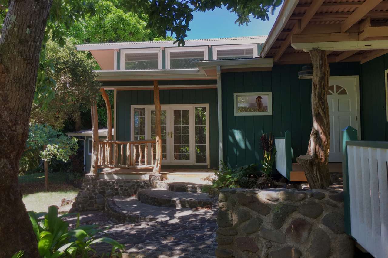 911 Kauhikoa Road Haiku, HI 96708 - Photo 1 of 30 a front view of a house with garden