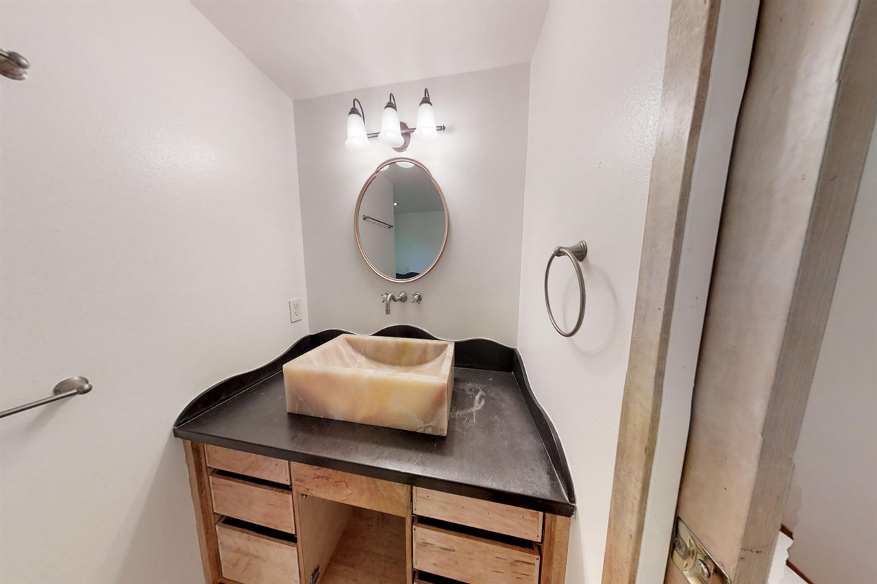 911 Kauhikoa Road Haiku, HI 96708 - Photo 16 of 30 a bathroom with a sink a vanity and a mirror