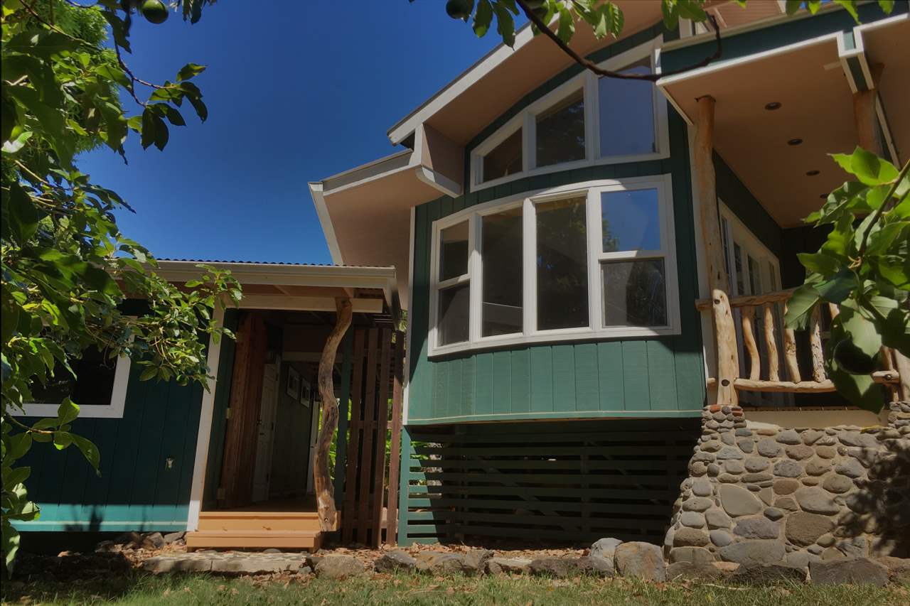911 Kauhikoa Road Haiku, HI 96708 - Photo 4 of 30 a front view of a house with a yard