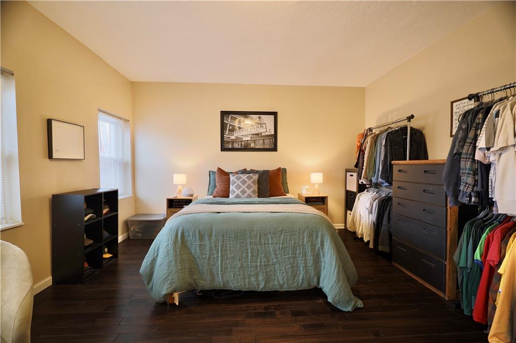 515 Lockhart Street, Unit 3 Pittsburgh, PA 15212 - Photo 27 of 27 a bedroom with a bed and wooden floor