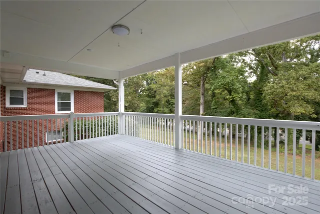 a house with green field in front of it