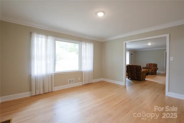 an empty room with closet and a window