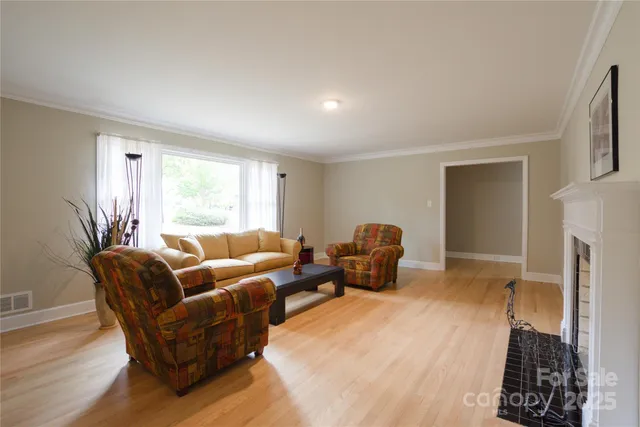 a living room with furniture a window and a fireplace