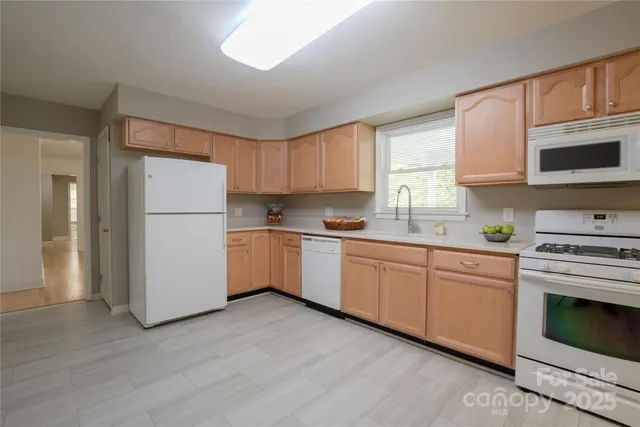 a kitchen with a refrigerator stove top oven and cabinets