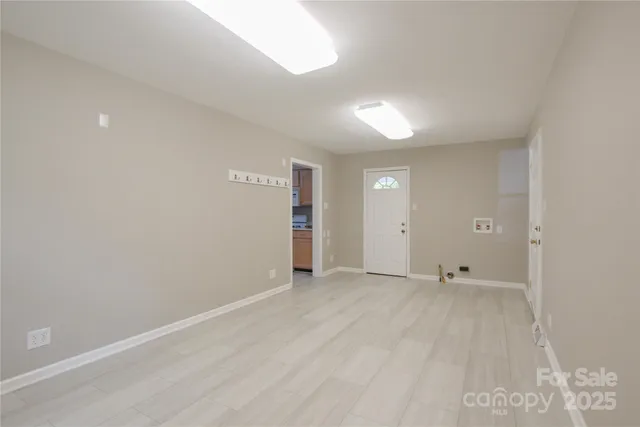 a view of an empty room with wooden floor