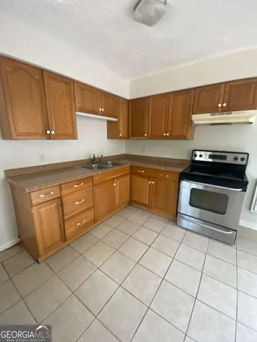 a kitchen with stainless steel appliances granite countertop a sink and cabinets