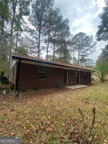 a view of a house with a large tree