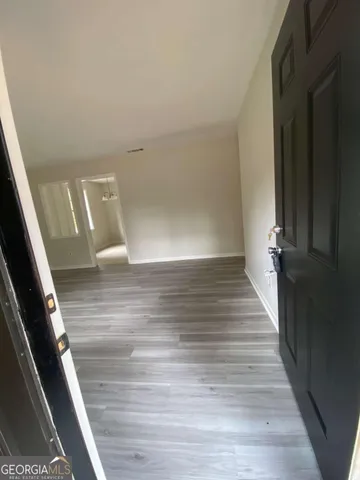 a view of a hallway view with wooden floor and staircase