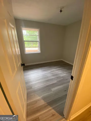 a view of an empty room and wooden floor