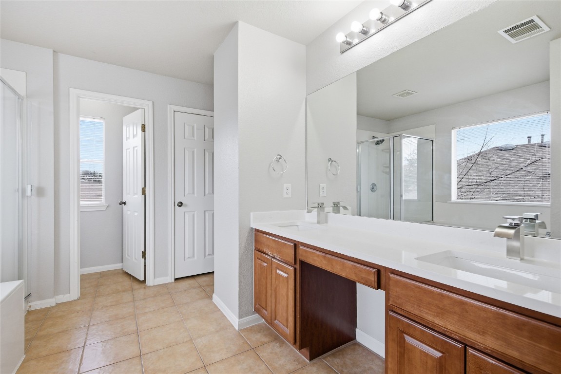 4410 Meadowside Lane Round Rock, TX 78665 - Photo 18 of 22 a bathroom with a sink double vanity and a mirror