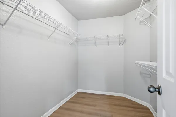 a view of a room with wooden floor