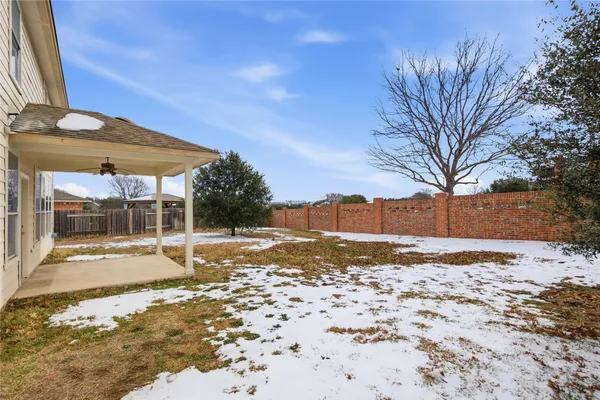 a backyard of a house with a yard and outdoor seating